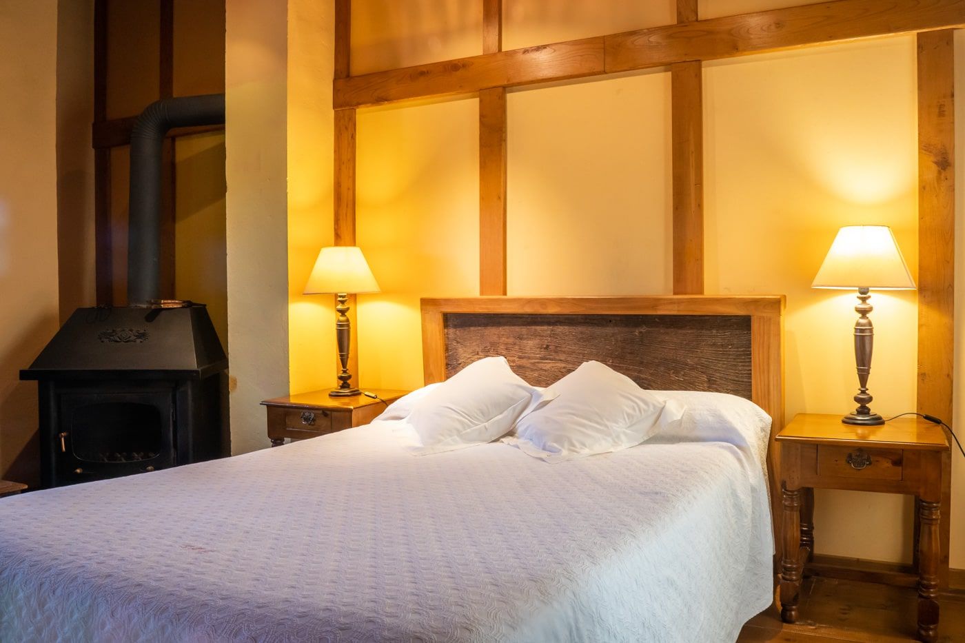 suites with fireplace in the room next to the bed in picos de europa